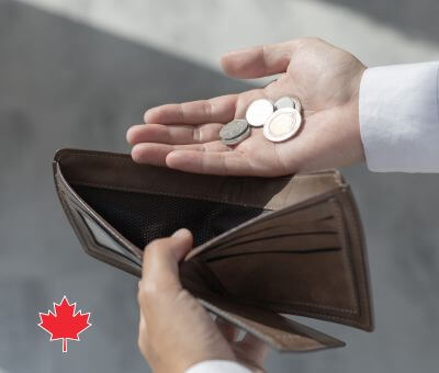 hand holding coins over wallet