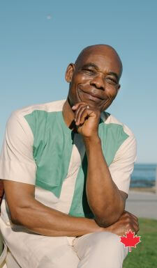 senior man sitting outside smiling